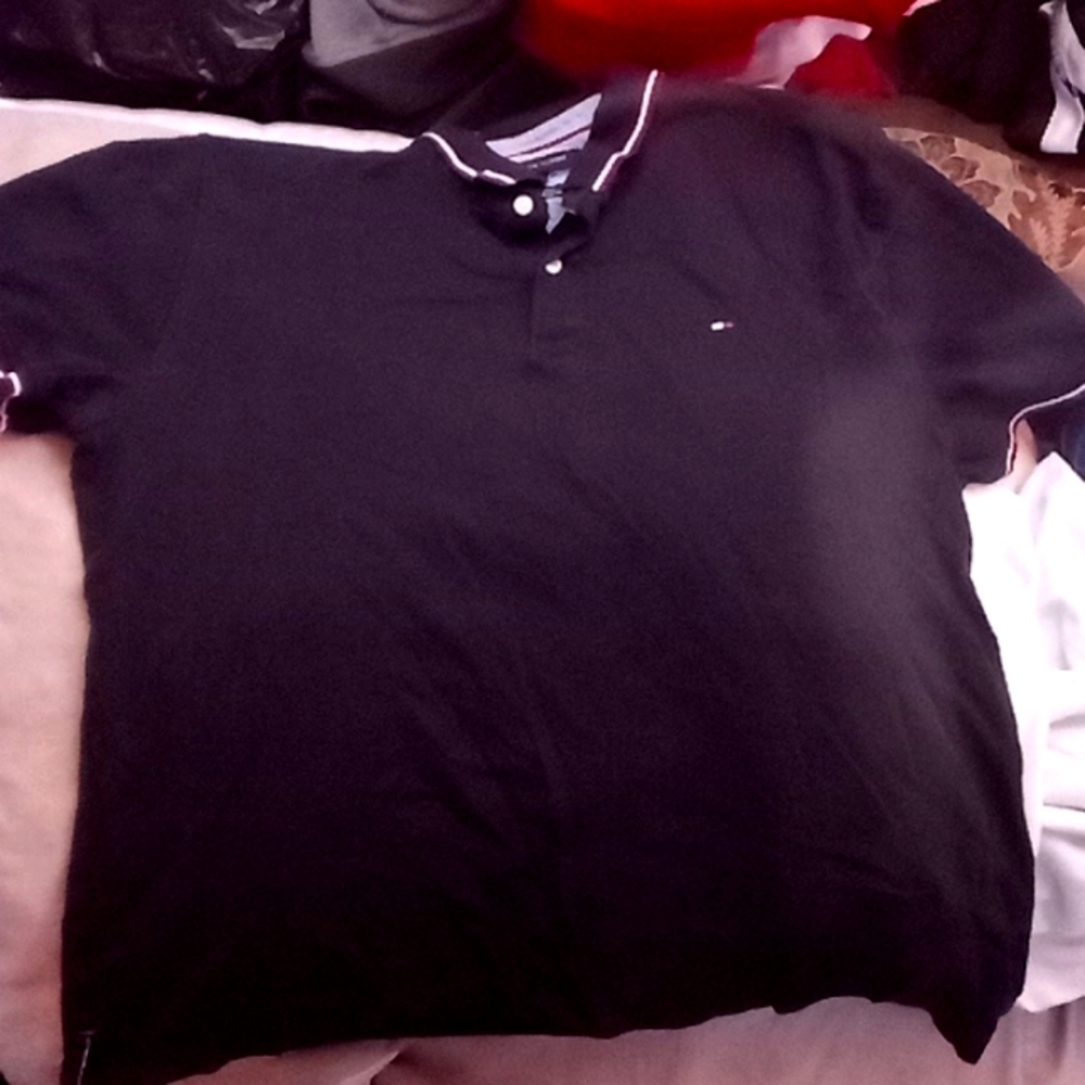Used condition Tommy Hilfiger Navy blue Polo shirt with Tommy logo.Size Large.